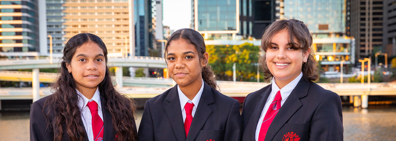 Image of three HMEF scholars in school uniforms